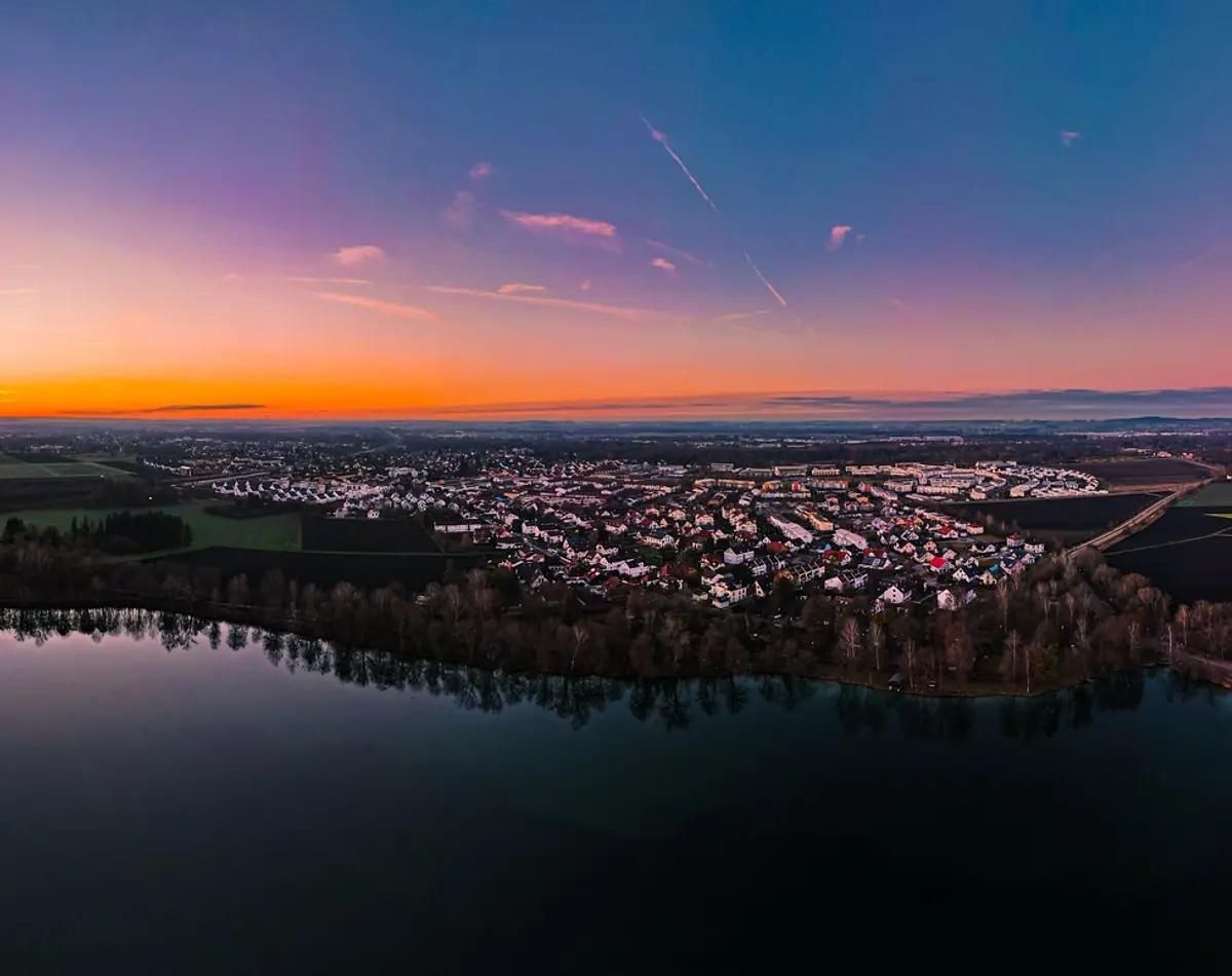 Eine Stadt in Bayern mit vielen Einfamilienhäusern im Sonnenuntergang.